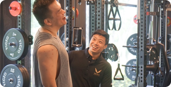 Two people exercising with professional fitness coach.