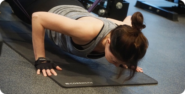 Two people exercising on yoga mat.