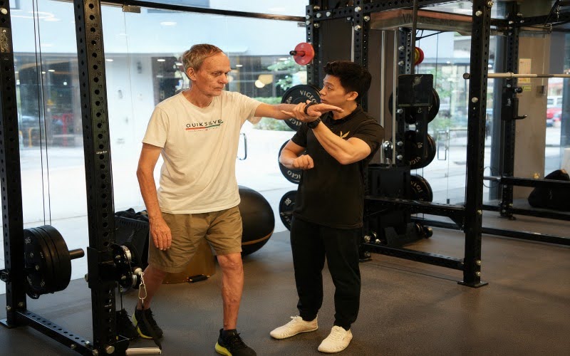 Senior man doing functional strength training with a personal trainer