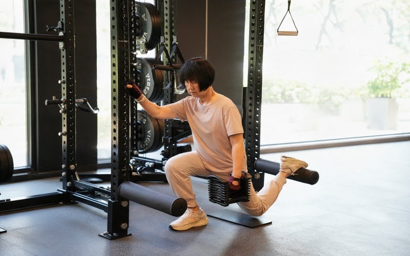 Senior woman performing split squats for leg strength and balance